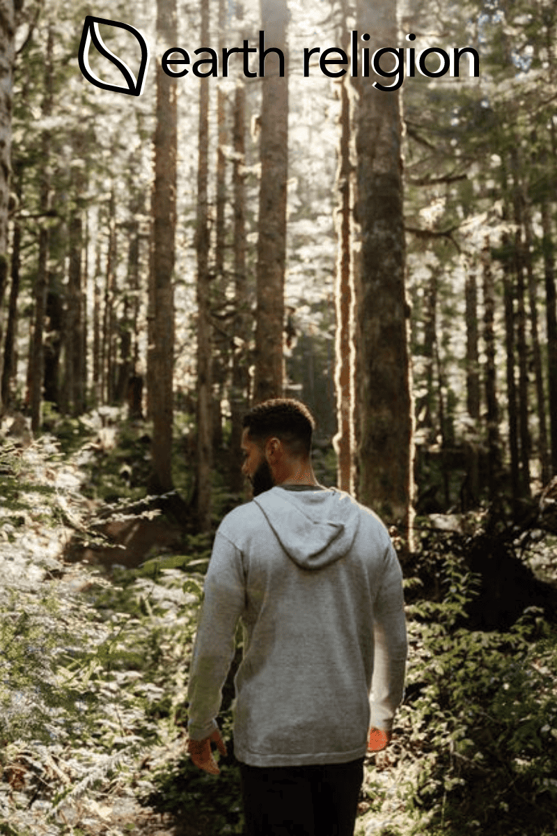 Man walking in the woods with an alpaca sweater on from Paka Apparel.